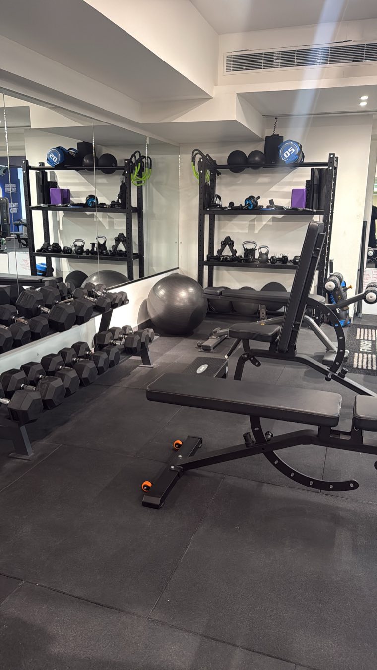 Treadmill and elliptical facing the glass wall of the pool